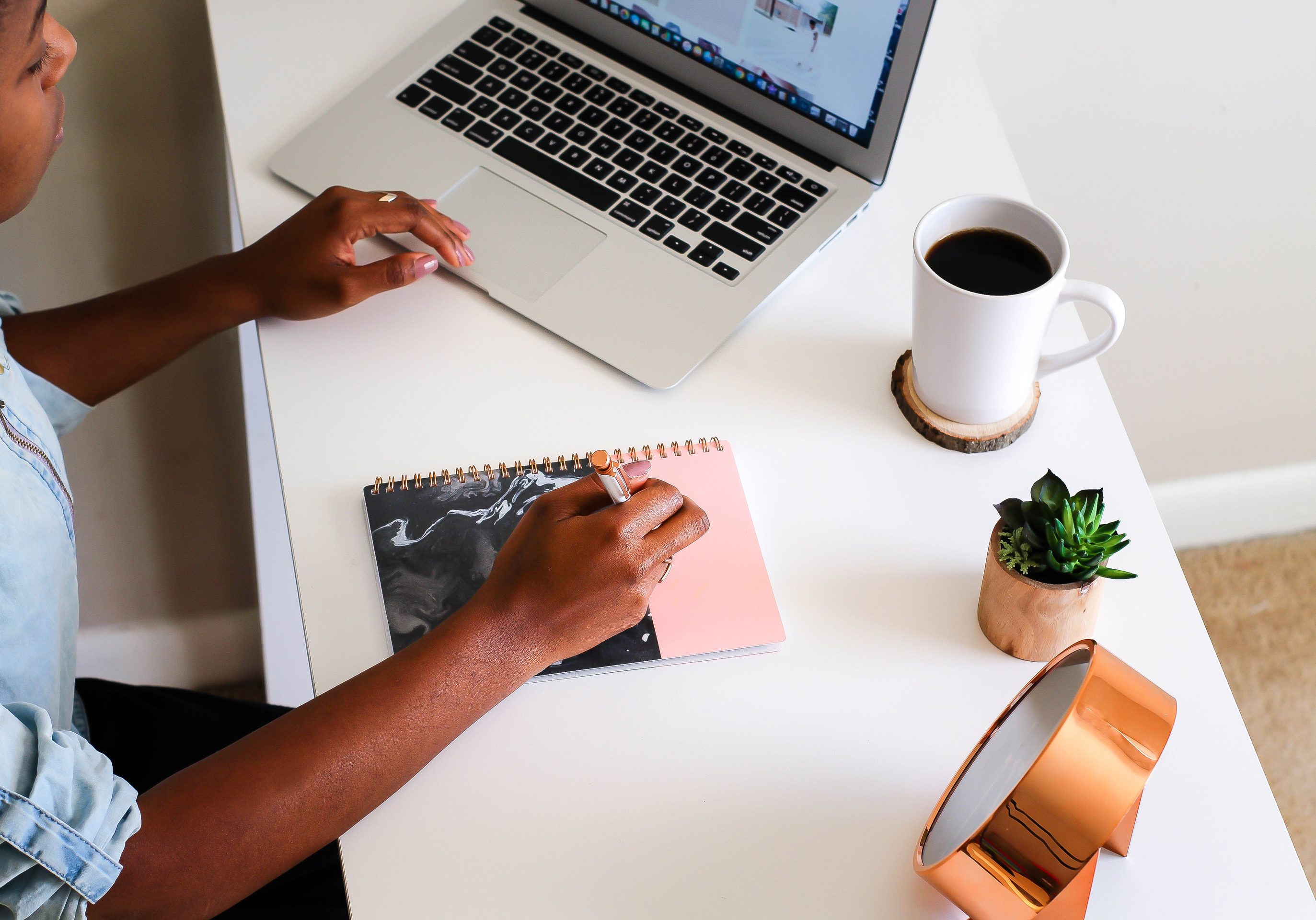 at computer desk writing